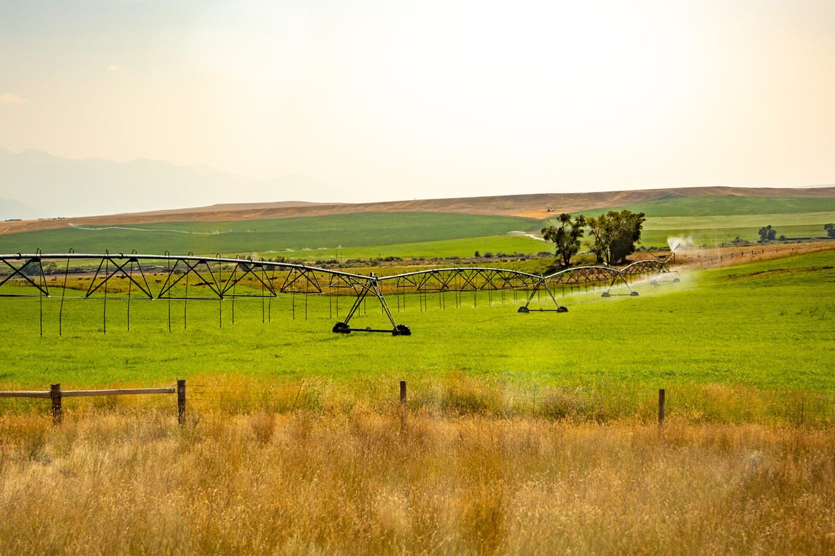 Center pivot irrigation system watering crops in a field